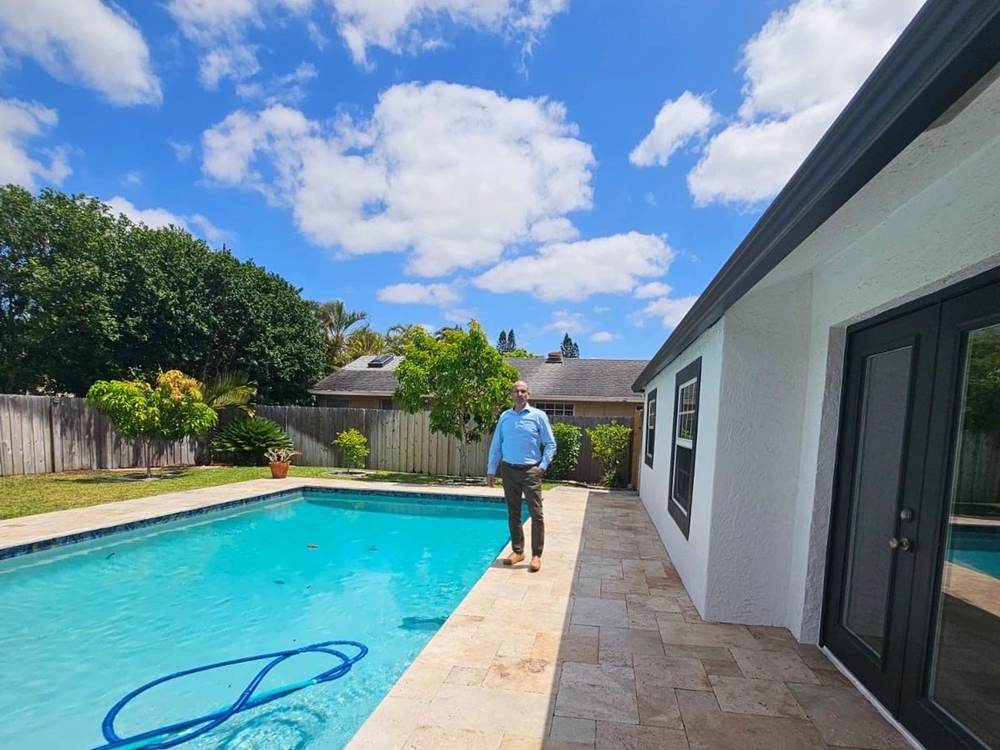 Backyard pool and patio at a home represented by Dgani Group in South Florida