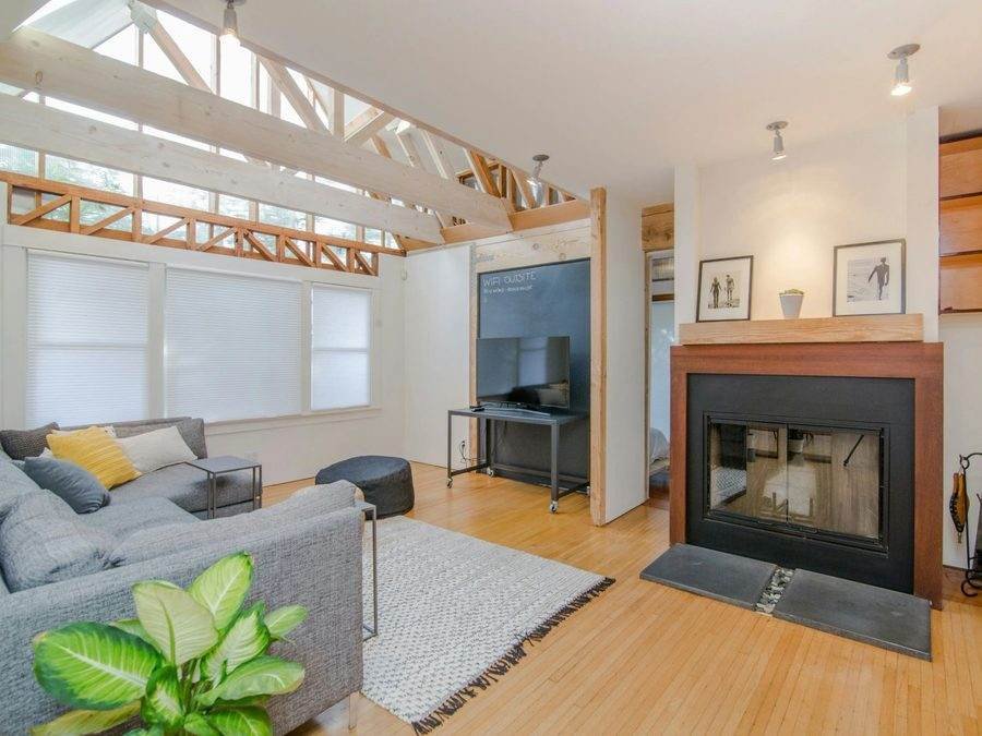Living room renovation with fireplace and skylight