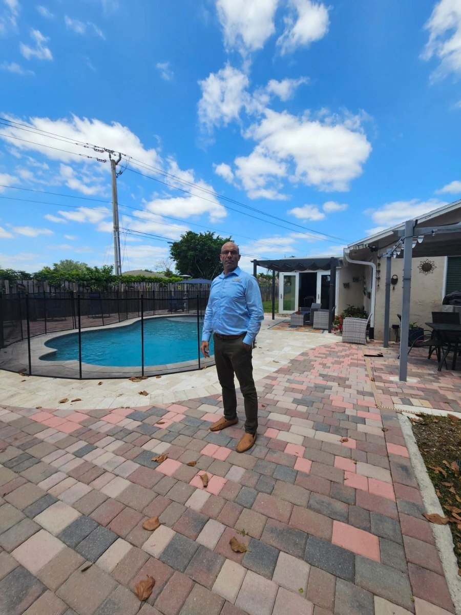 Shalom Dgani of Dgani Group on the pool deck of a South Florida home