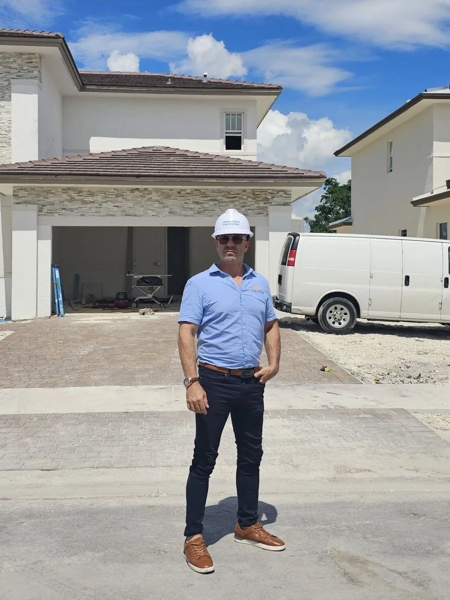 Shalom Dgani of Dgani Group in a hard hat at a South Florida new-construction home