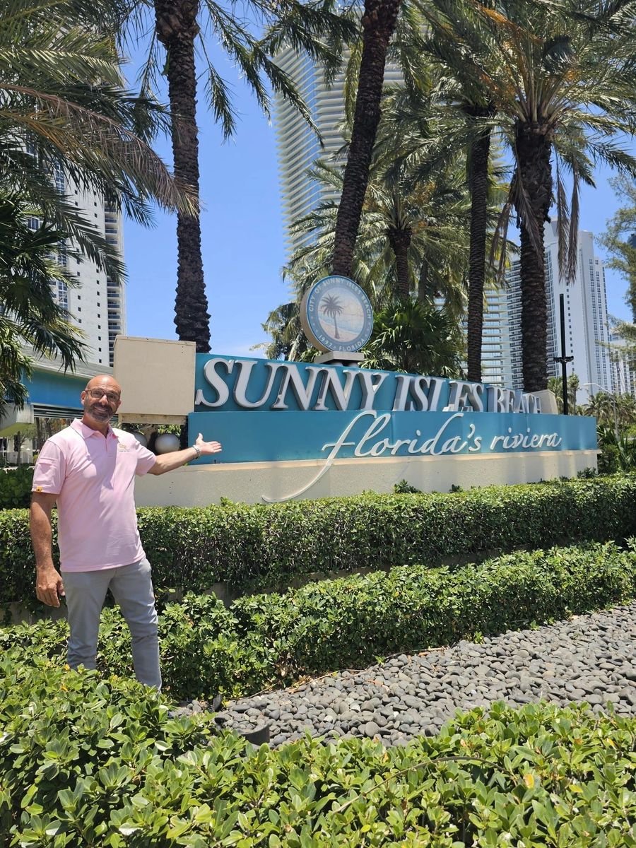 Shalom Dgani of Dgani Group at the Sunny Isles Beach, Florida's Riviera city sign